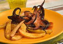 Polpi al forno con patate-Baked octopuses with potatoes.