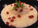 Risotto allo spumante, tartare di scampi e melograno.