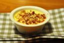 Panna cotta al Parmigiano Reggiano con crumble di bacon e pinoli