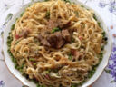 Corona di tagliatelle bocconcini di carne, piselli e prosciutto