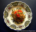 Spaghetti con patè di olive nere ,  datterini al forno e gocce di pesto di pistacchio