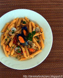 Penne rigate con vongole , cozze e pomodori secchi